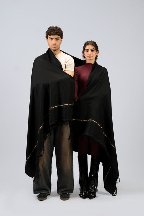 Black wool blanket scarf styled as two-person shawl wrap