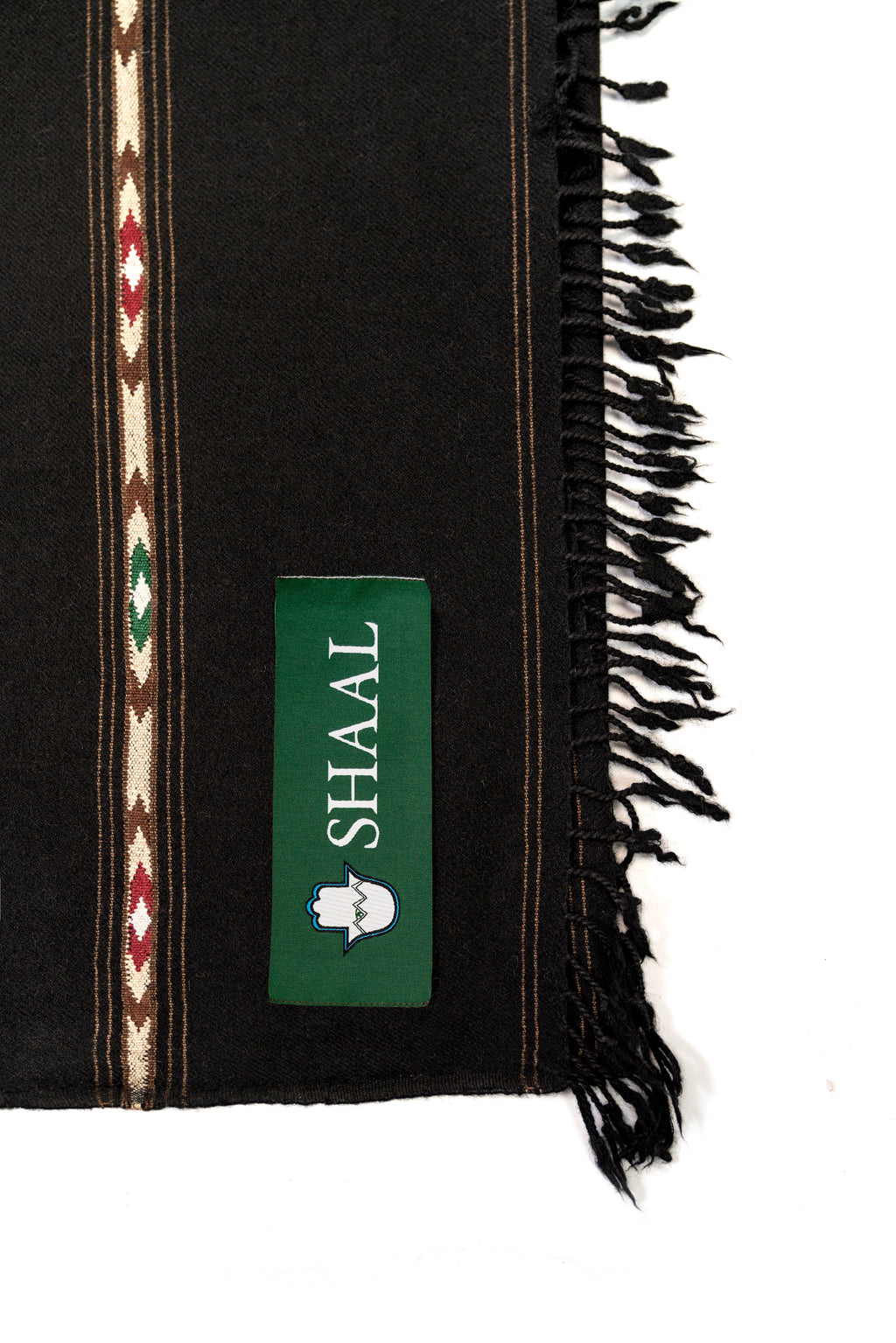 Black lambs wool wrap with decorative stripes and a green label on a white background
