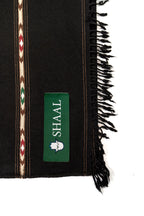 Black lambs wool wrap with decorative stripes and a green label on a white background