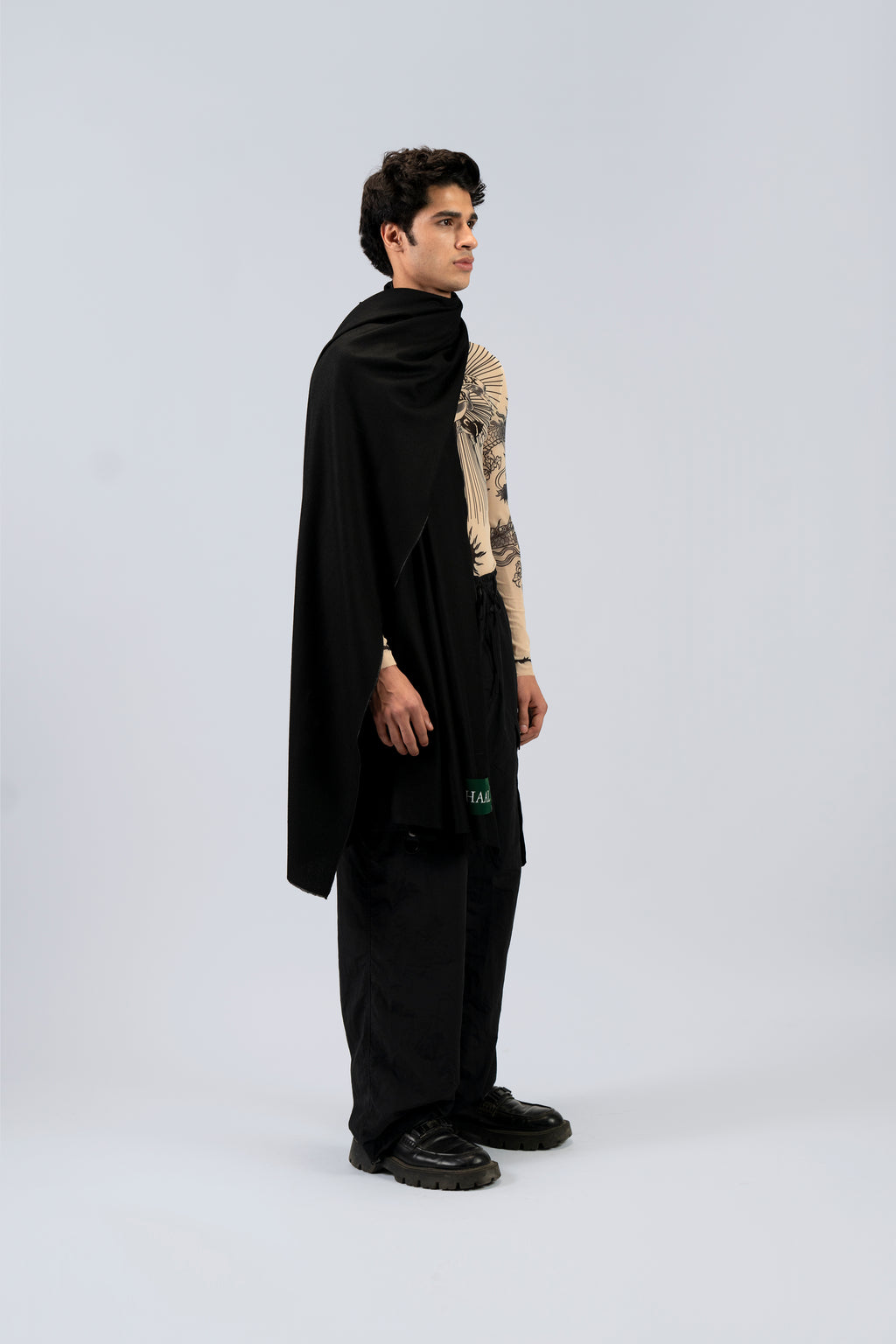 Black midweight wool shawl from behind on male model in printed top, three-quarter back view