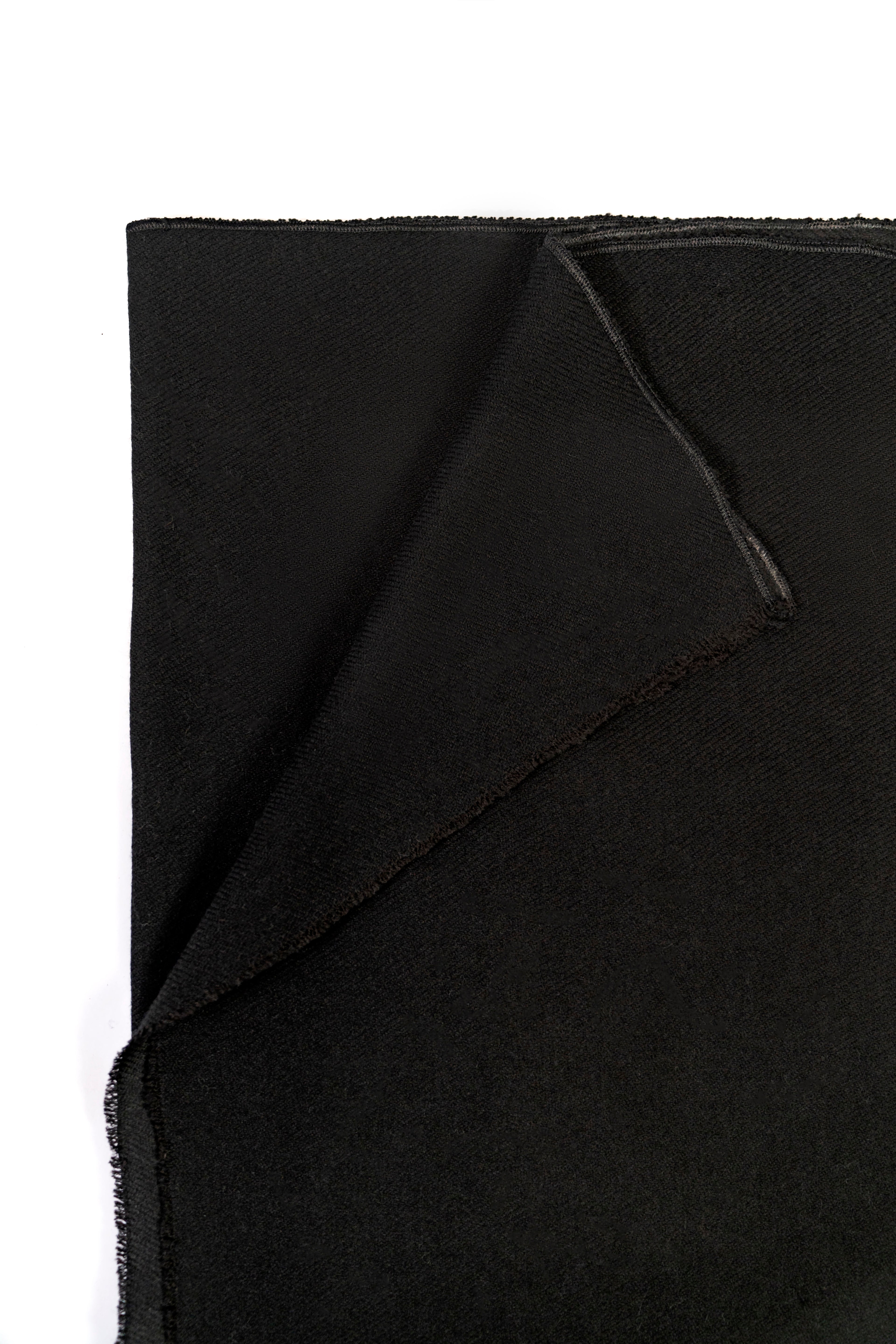 Black midweight wool shawl folded corner on white background