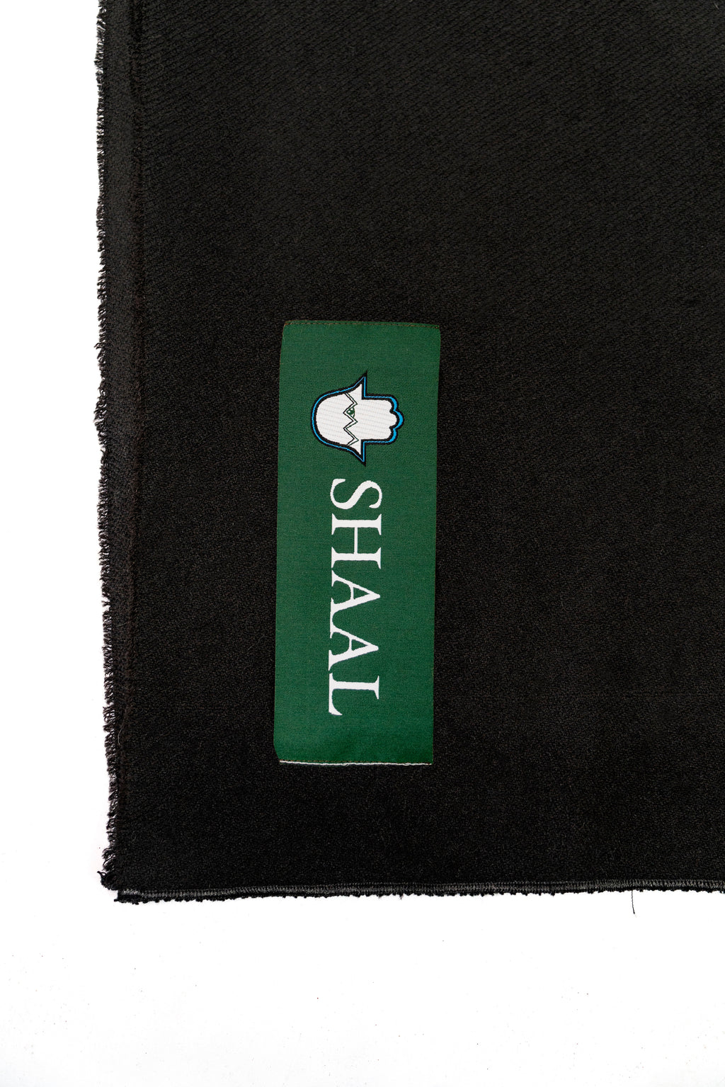 Black midweight wool shawl detail of green SHAAL woven label