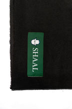 Black midweight wool shawl detail of green SHAAL woven label