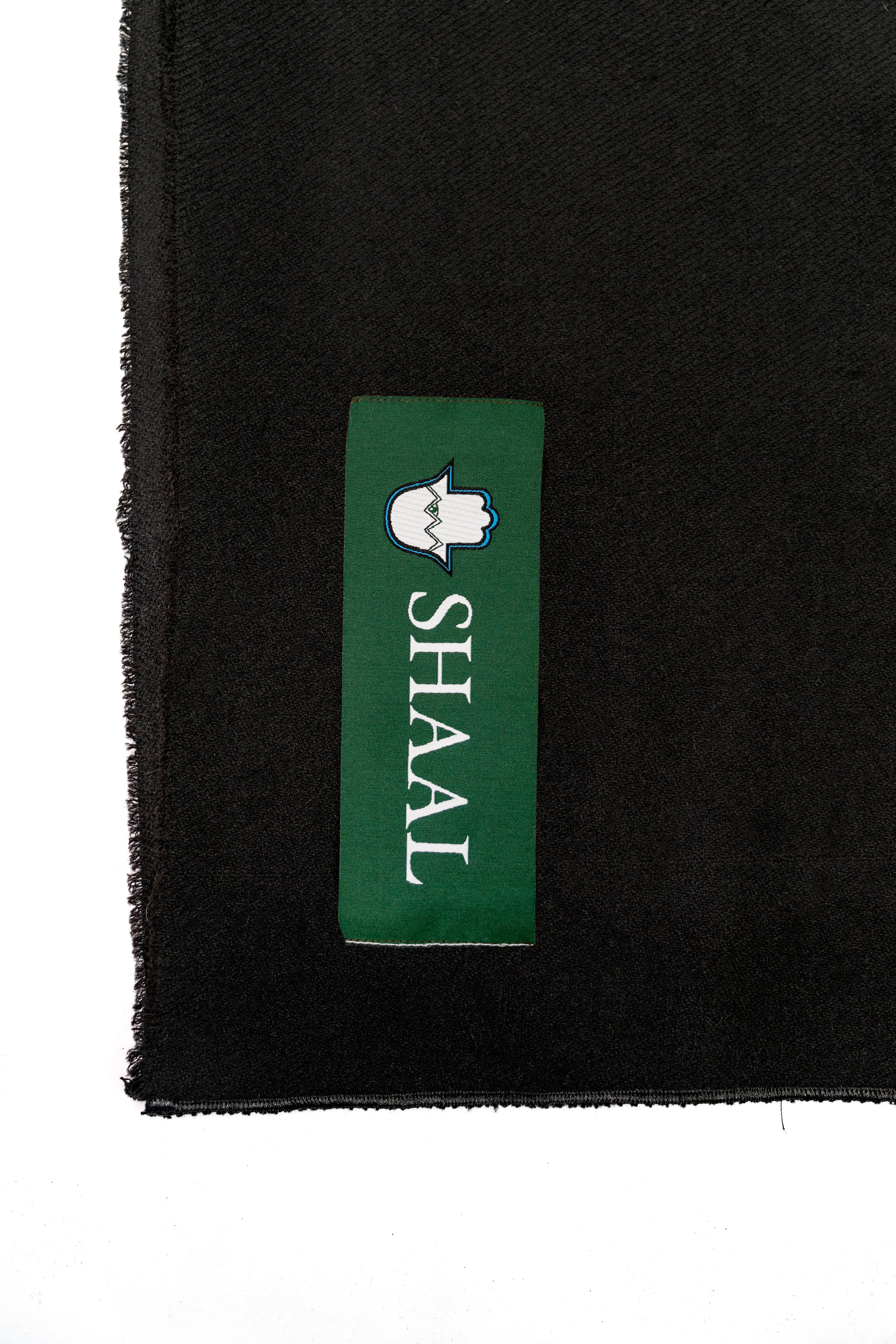 Black midweight wool shawl detail of green SHAAL woven label