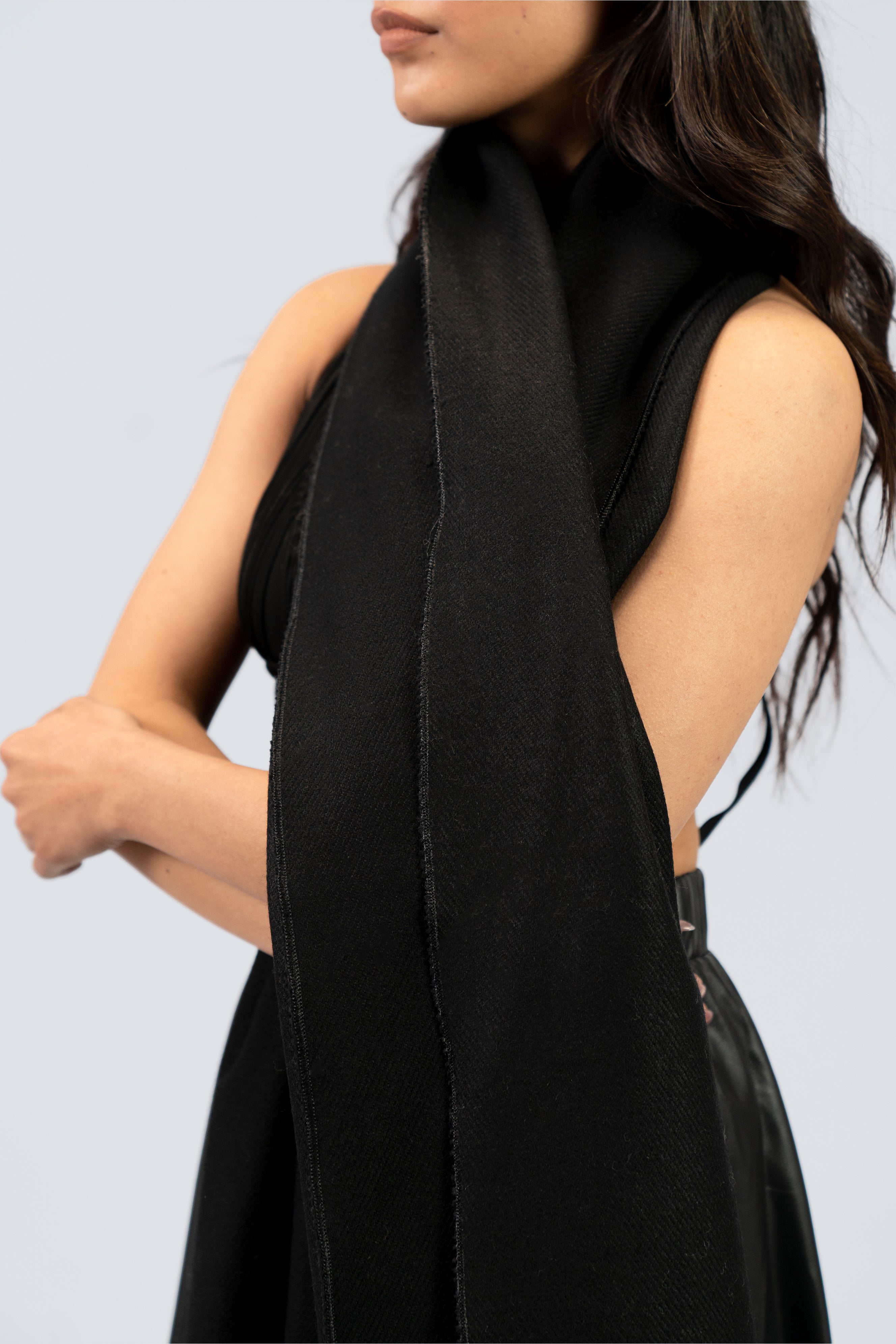 Black midweight wool shawl close-up draped over shoulder, female model mid-body view