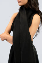 Black midweight wool shawl close-up draped over shoulder, female model mid-body view