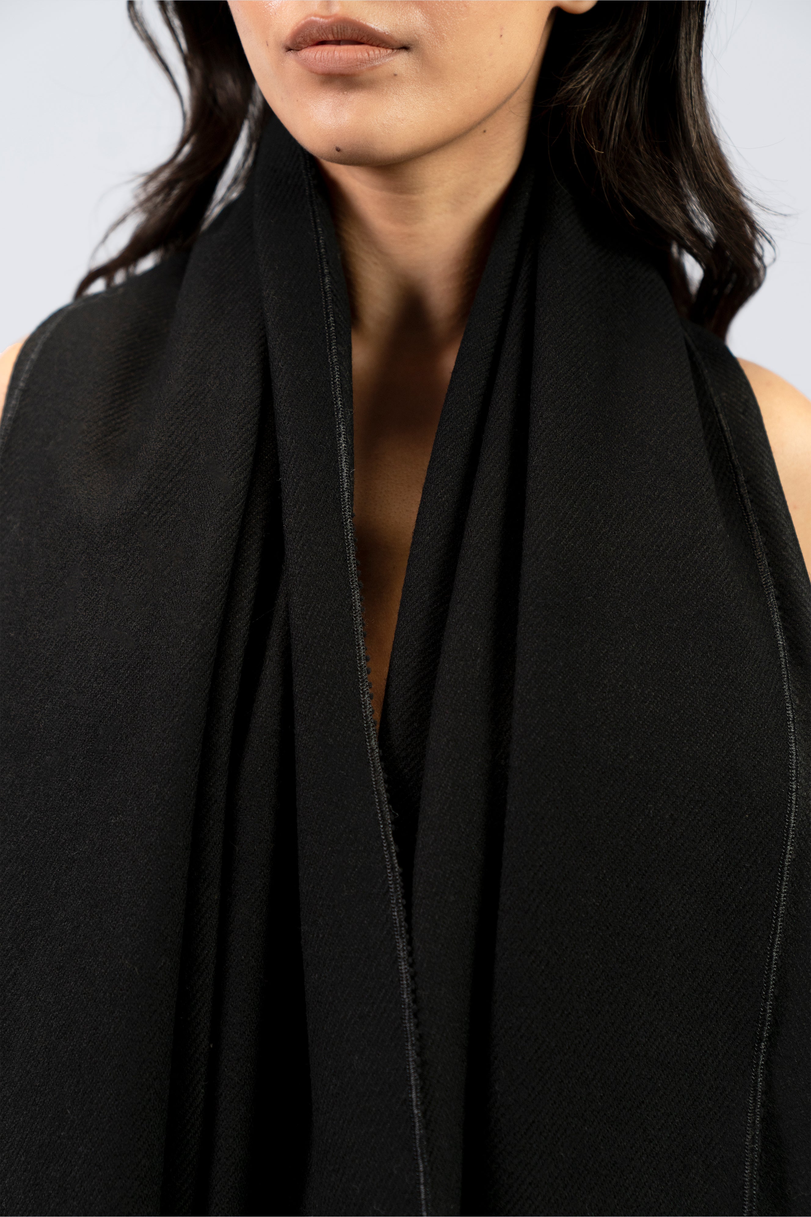 Black midweight wool shawl close-up wrapped around neck of female model