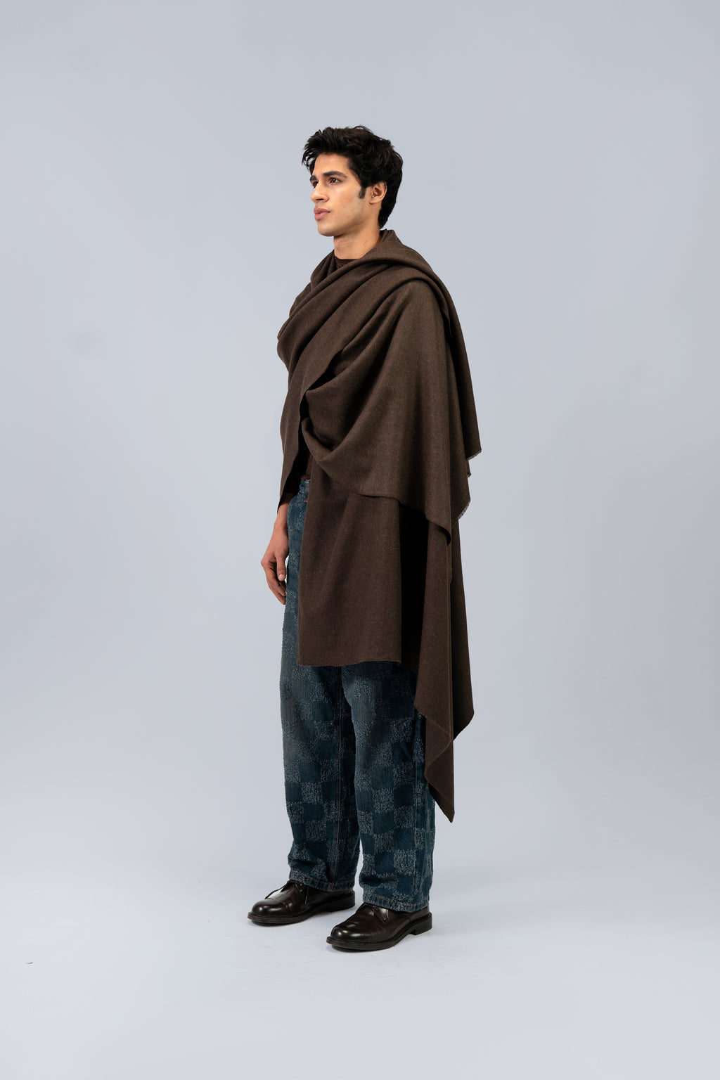 Brown handwoven wool shawl worn by model, side view