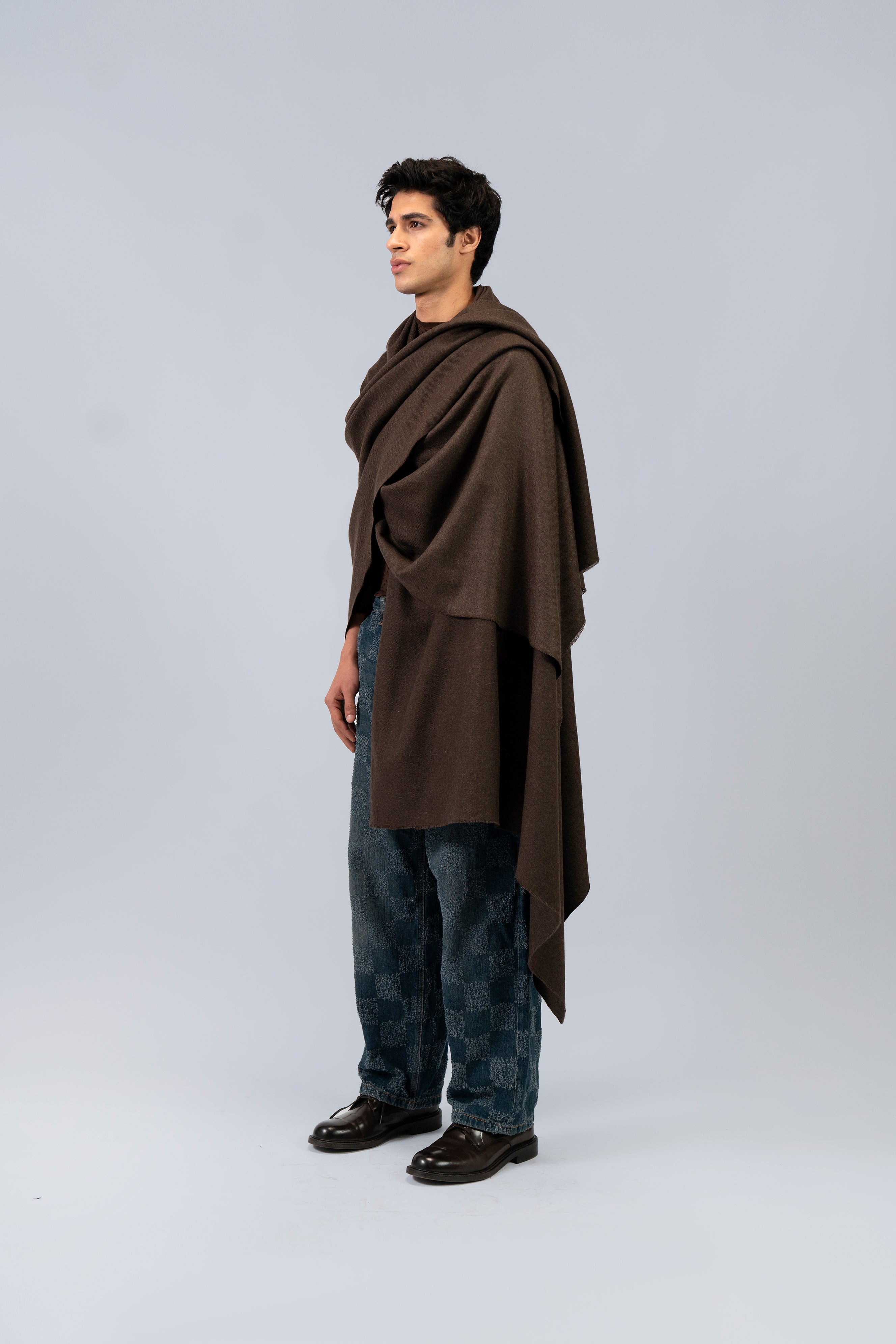 Brown handwoven wool shawl worn by model, side view