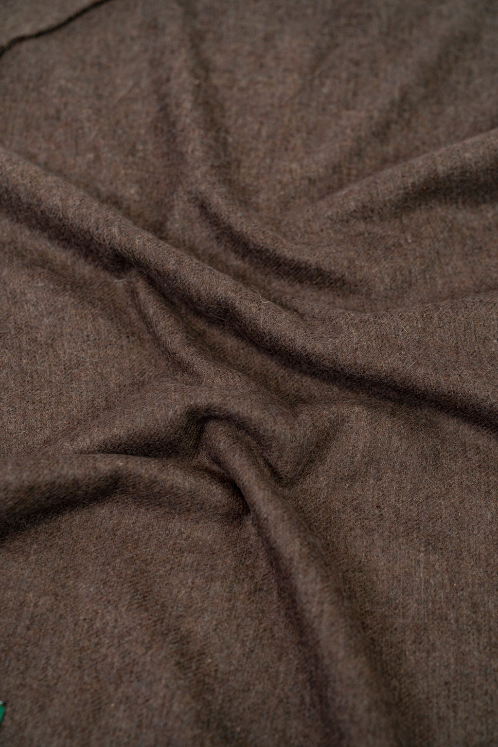 Brown handwoven wool shawl fabric texture detail