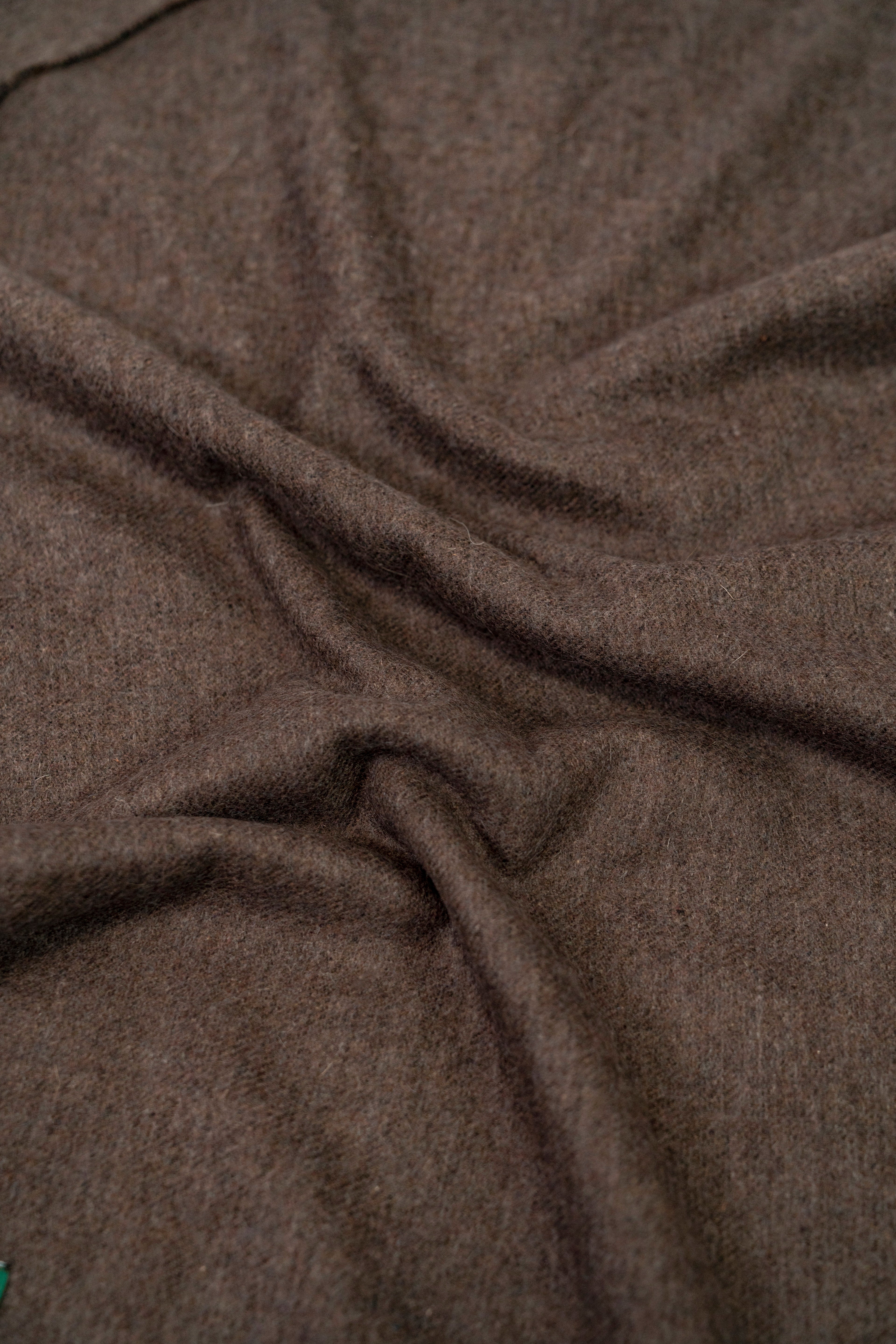 Brown handwoven wool shawl fabric texture detail