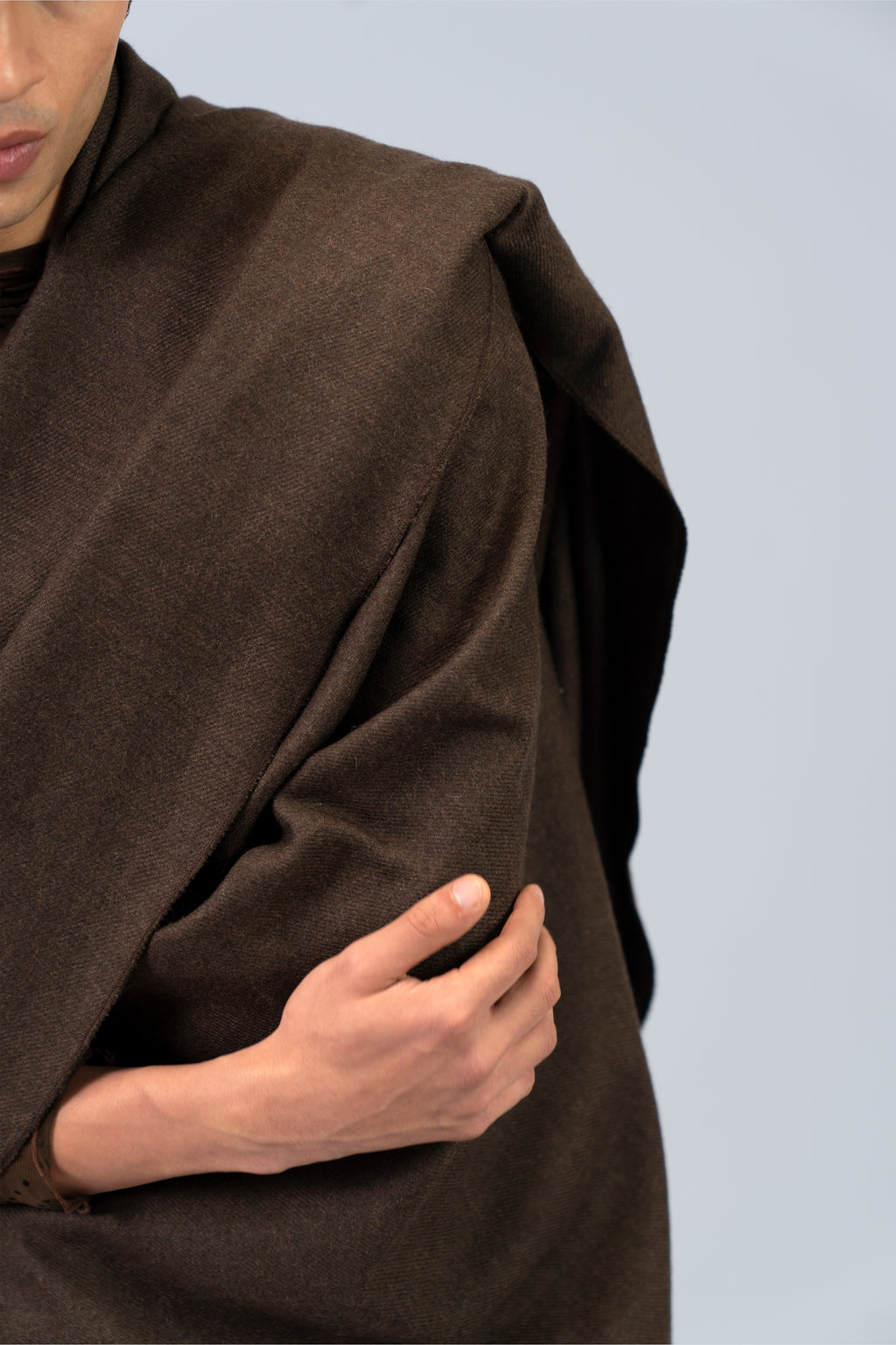 Brown handwoven wool shawl close-up with draped fold detail