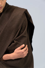 Brown handwoven wool shawl close-up with draped fold detail