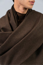 Brown handwoven wool shawl fabric detail draped over shoulders