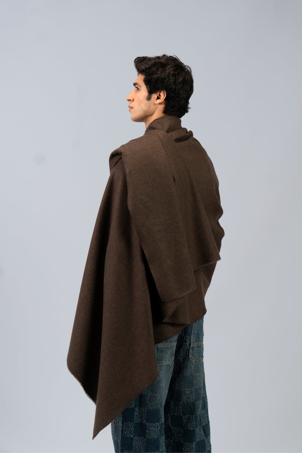 Brown handwoven wool shawl worn by model, back view