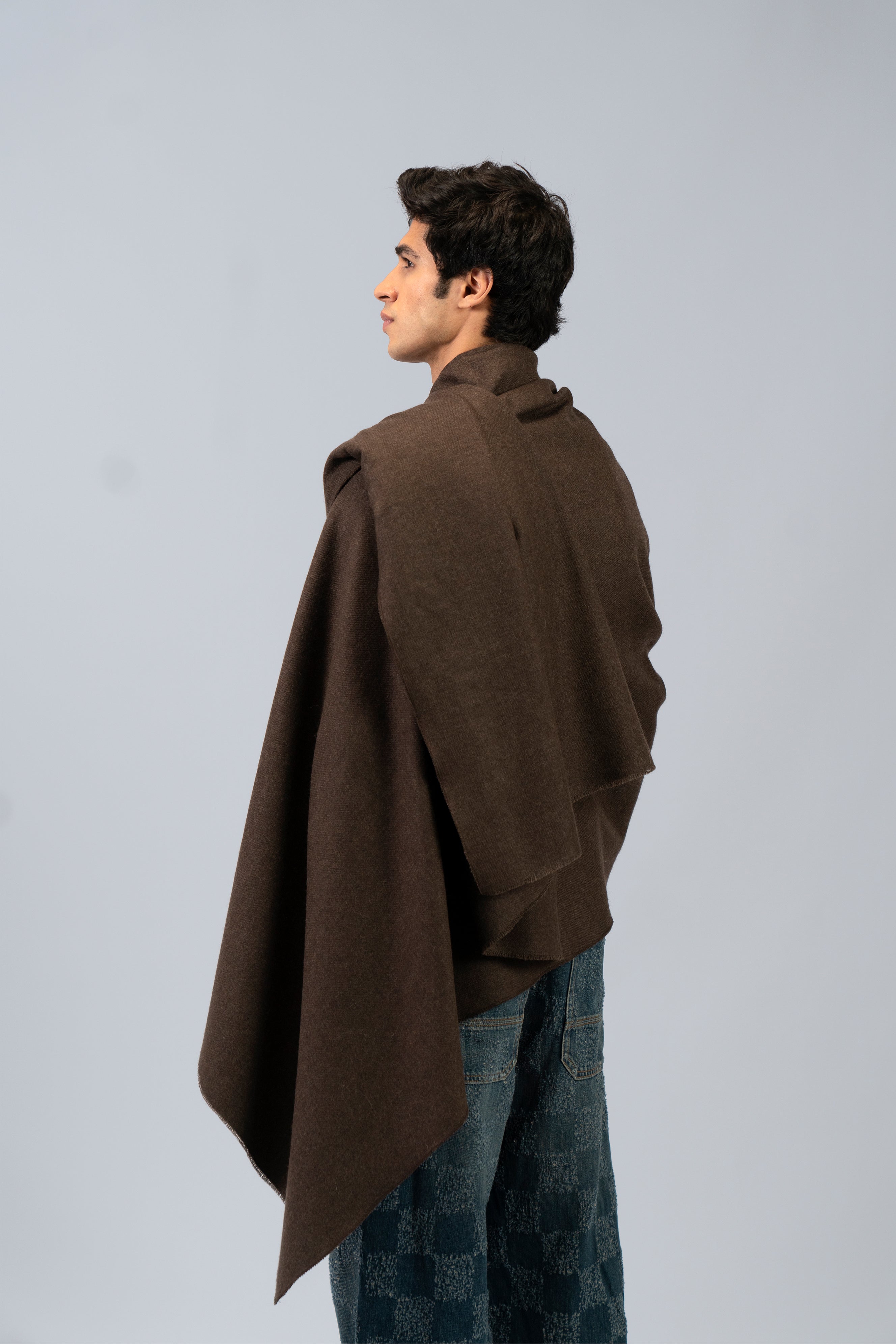 Brown handwoven wool shawl worn by model, back view