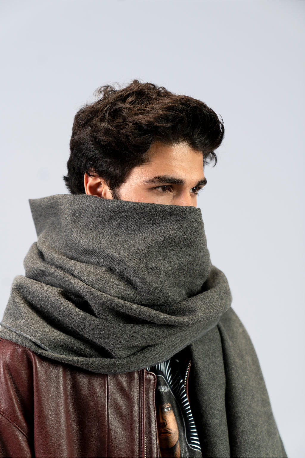 Gray handwoven wool shawl wrapped around model, close-up view