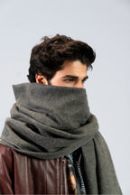 Gray handwoven wool shawl wrapped around model, close-up view