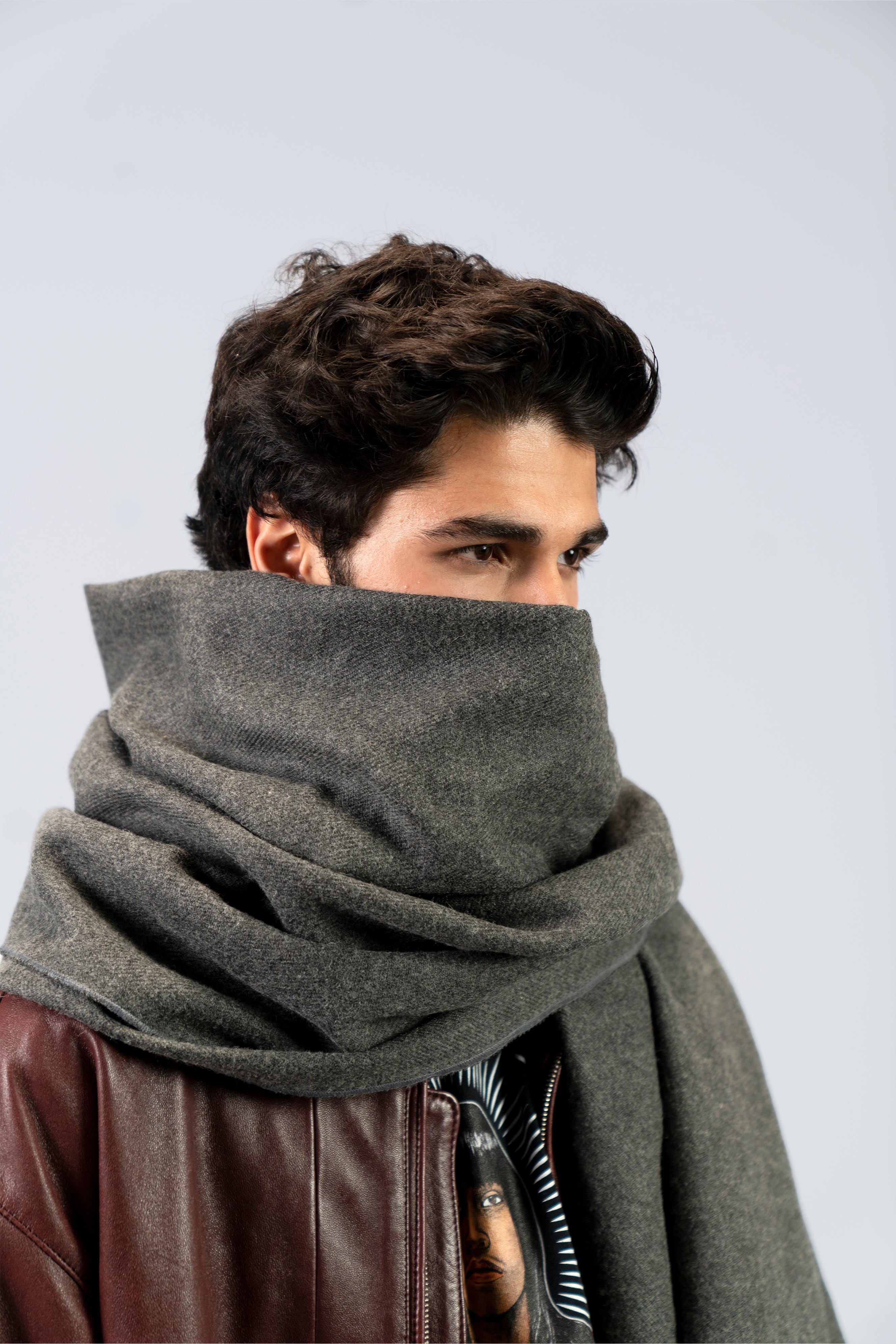 Gray handwoven wool shawl wrapped around model, close-up view