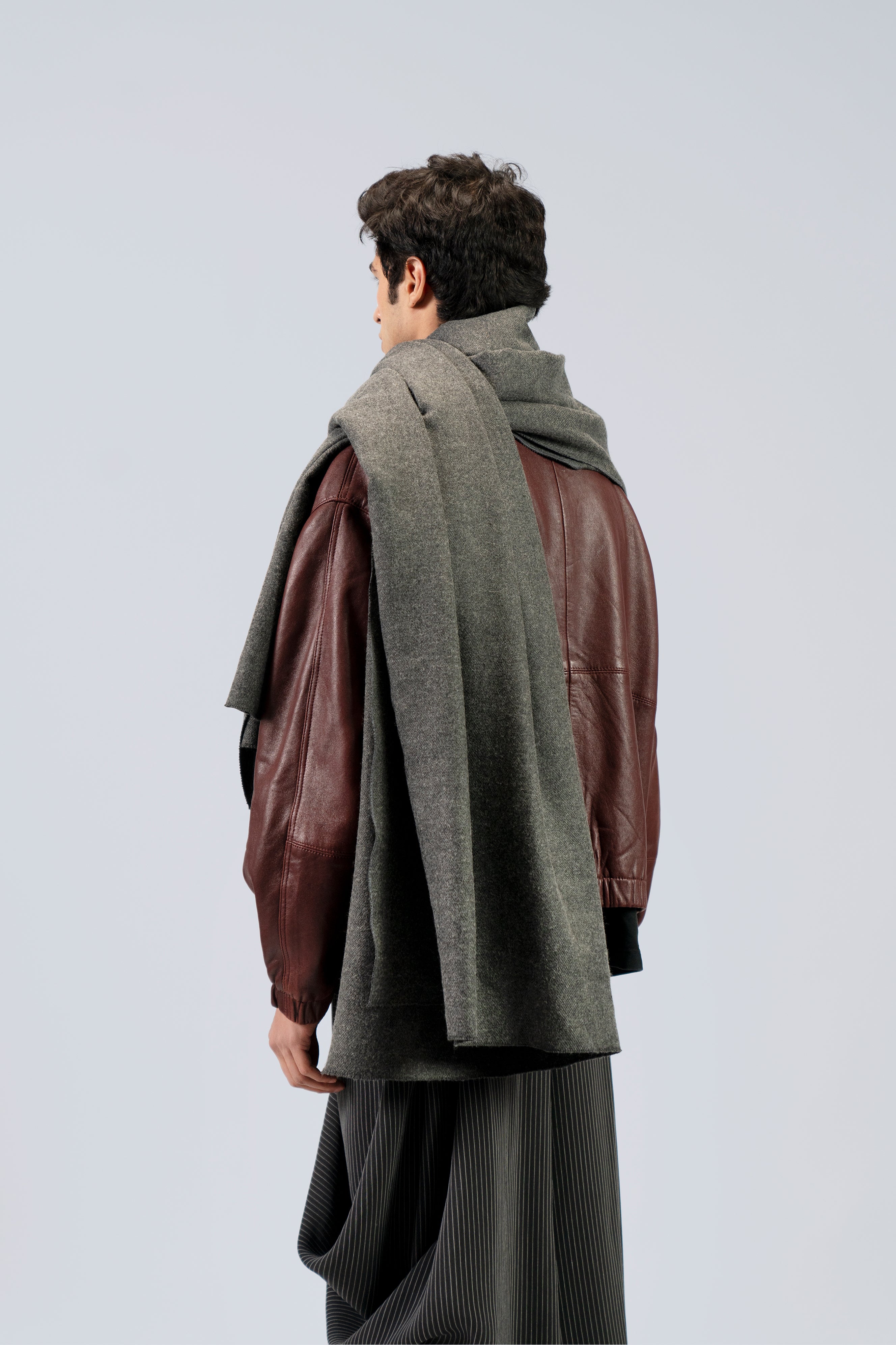 Gray handwoven wool shawl worn by model, back view