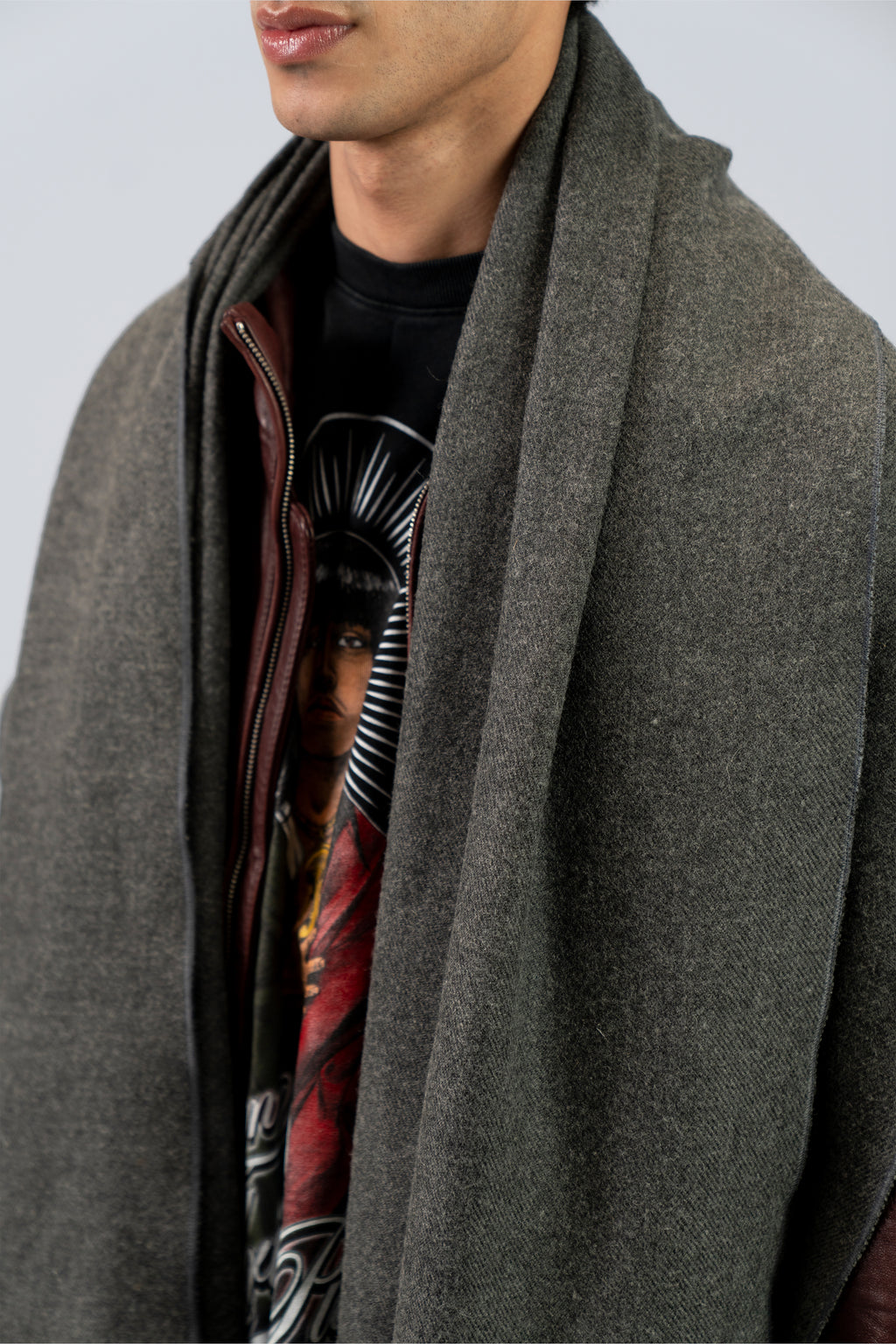 Gray handwoven wool shawl draped over shoulders, close-up detail