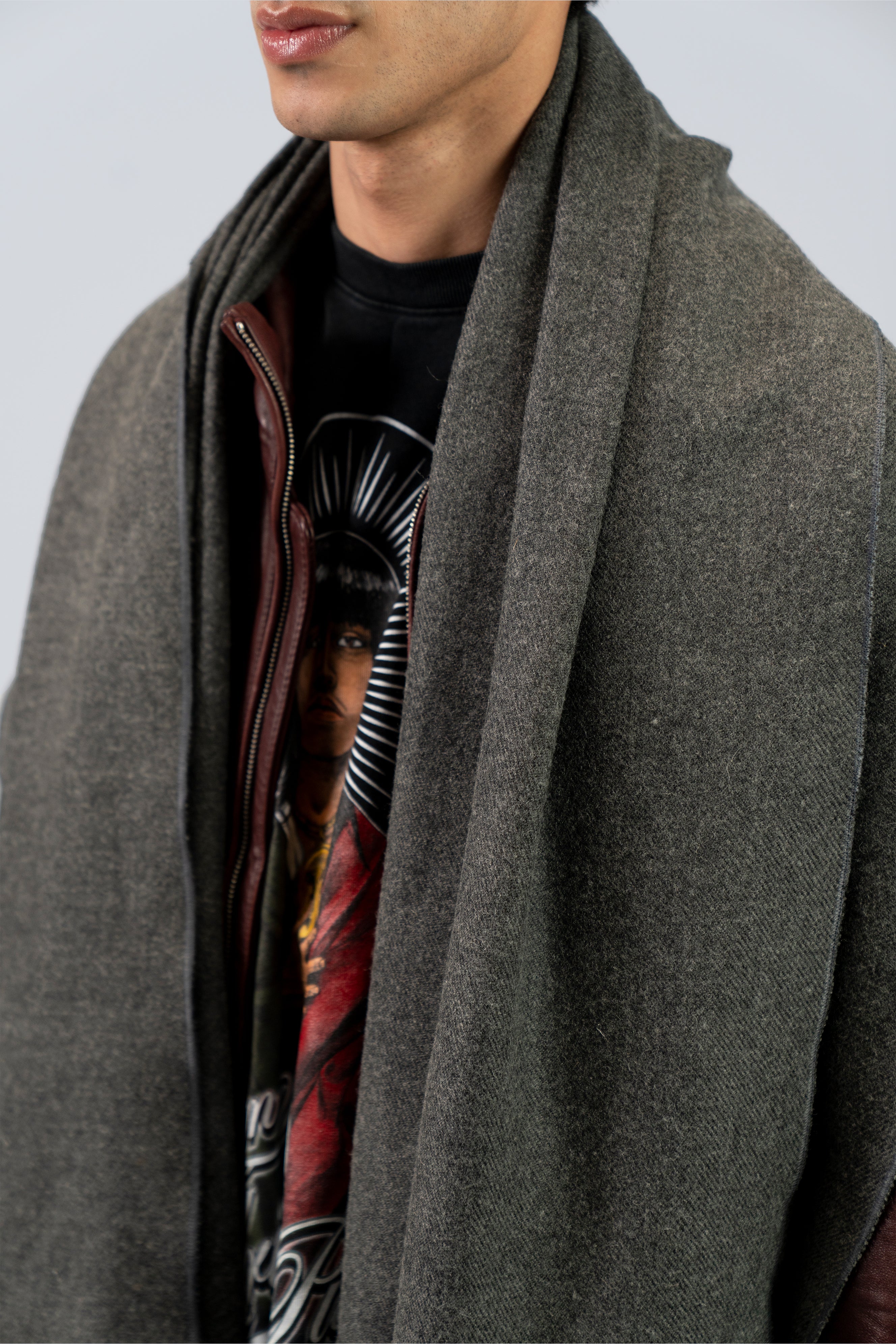 Gray handwoven wool shawl draped over shoulders, close-up detail