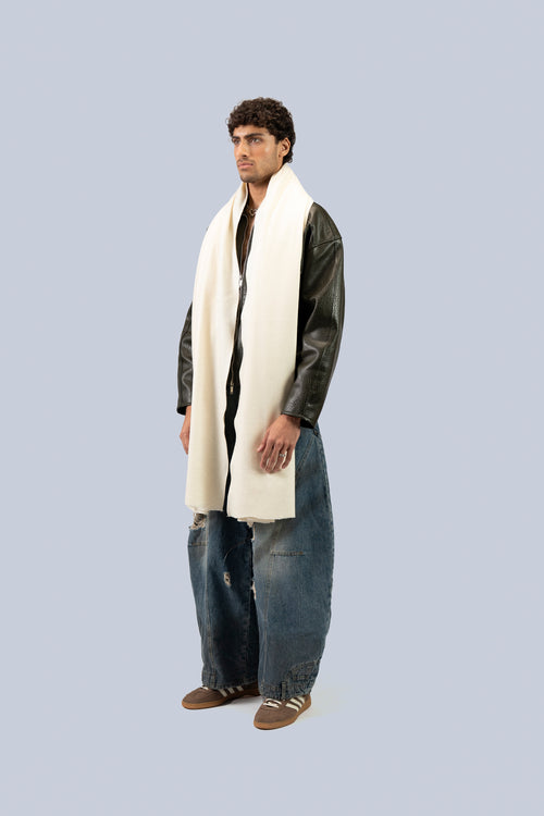 Off White heavyweight lamb wool shawl draped on male model in leather jacket, full-length three-quarter view