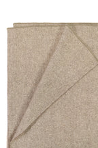 Folded Beige Shawl close-up on white background