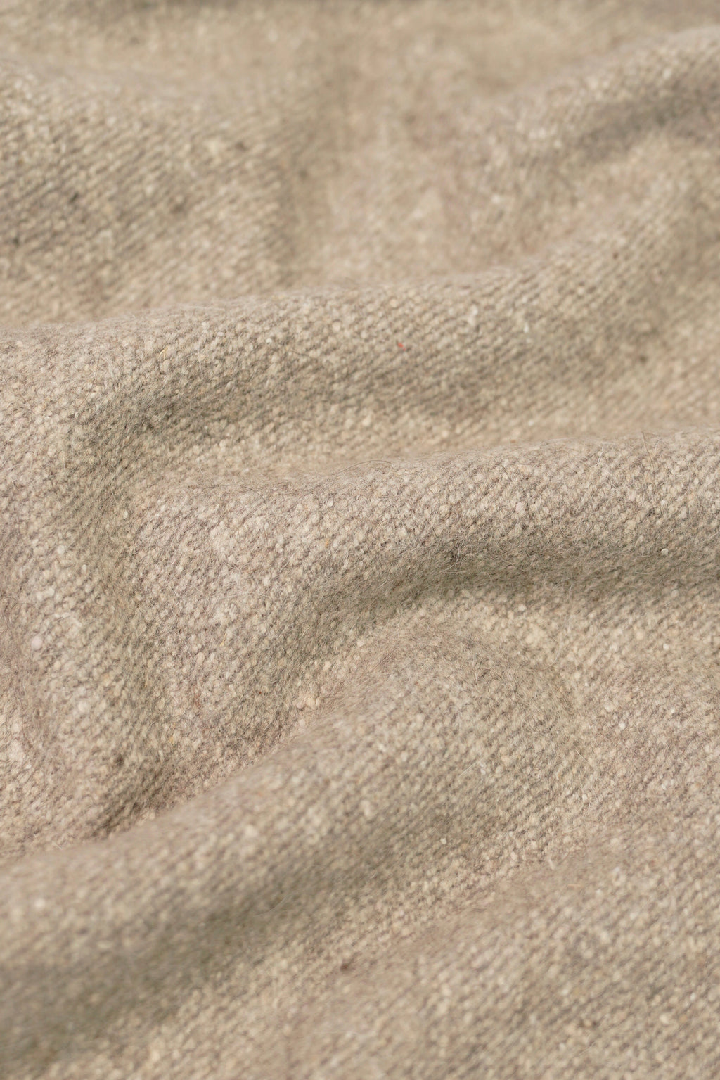 beige yak wool shawl worn by a woman, handwoven by SHAAL