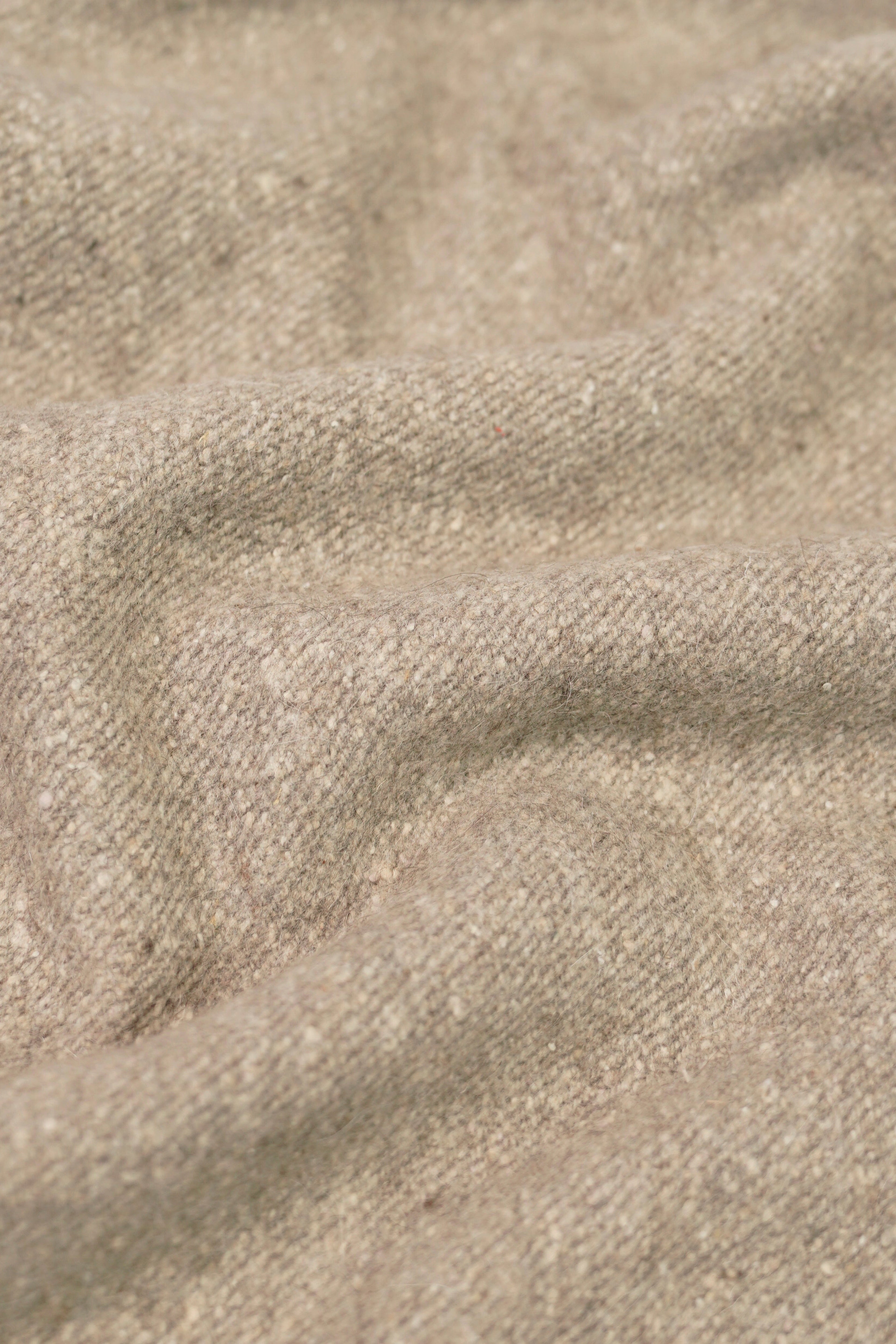 beige yak wool shawl worn by a woman, handwoven by SHAAL