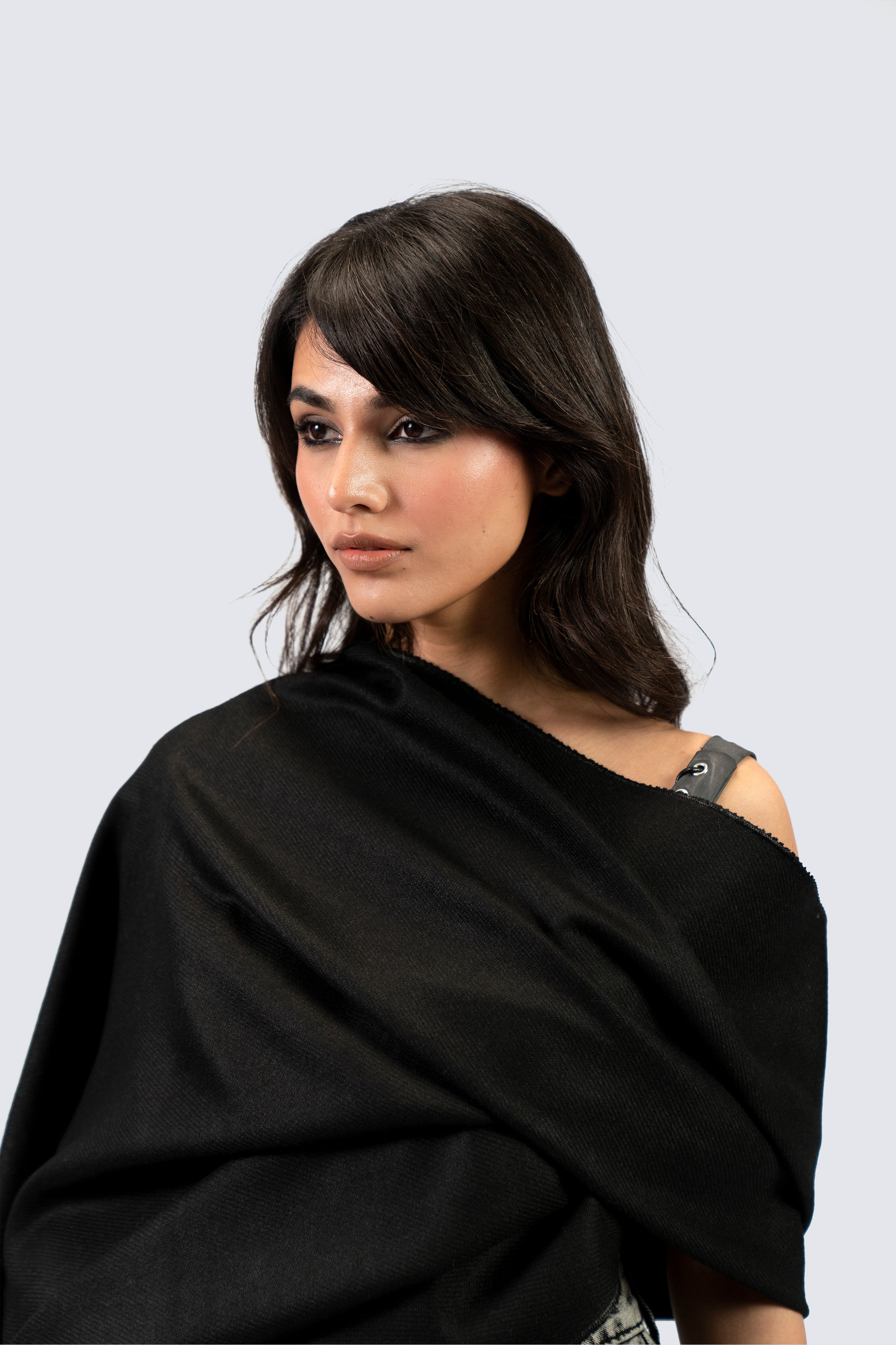 Black pashmina shawl close-up portrait on female model, three-quarter view