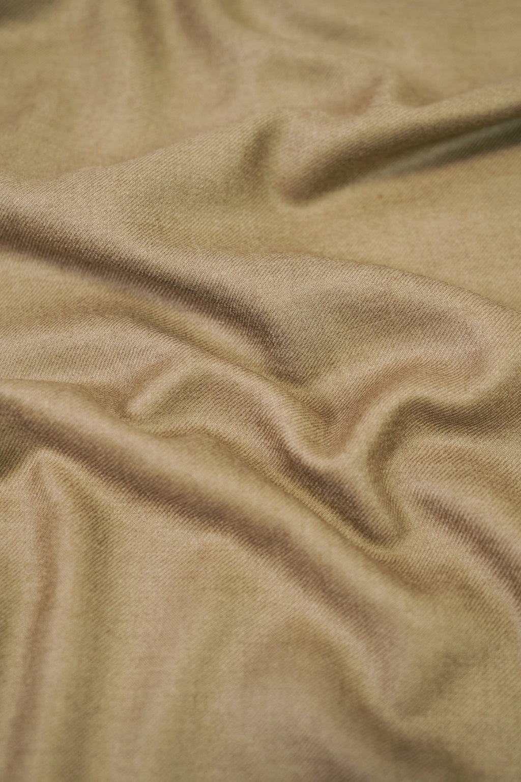 Gold pashmina shawl close-up of soft cashmere-blend fabric weave
