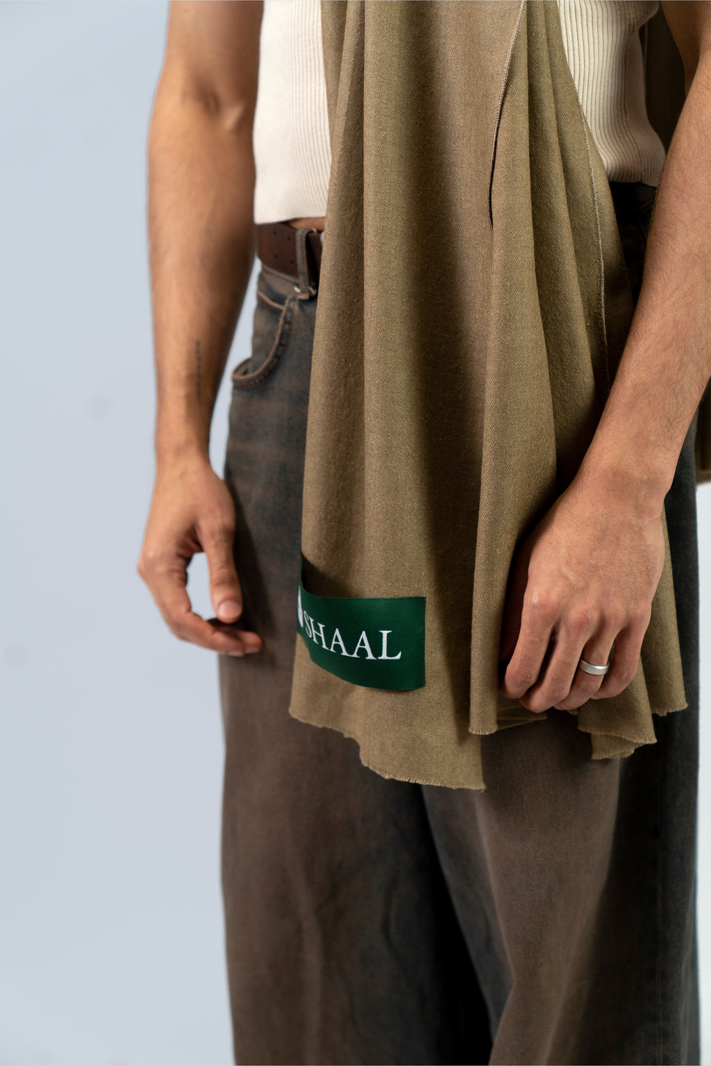 Gold pashmina shawl mid-body close-up with SHAAL label on male model