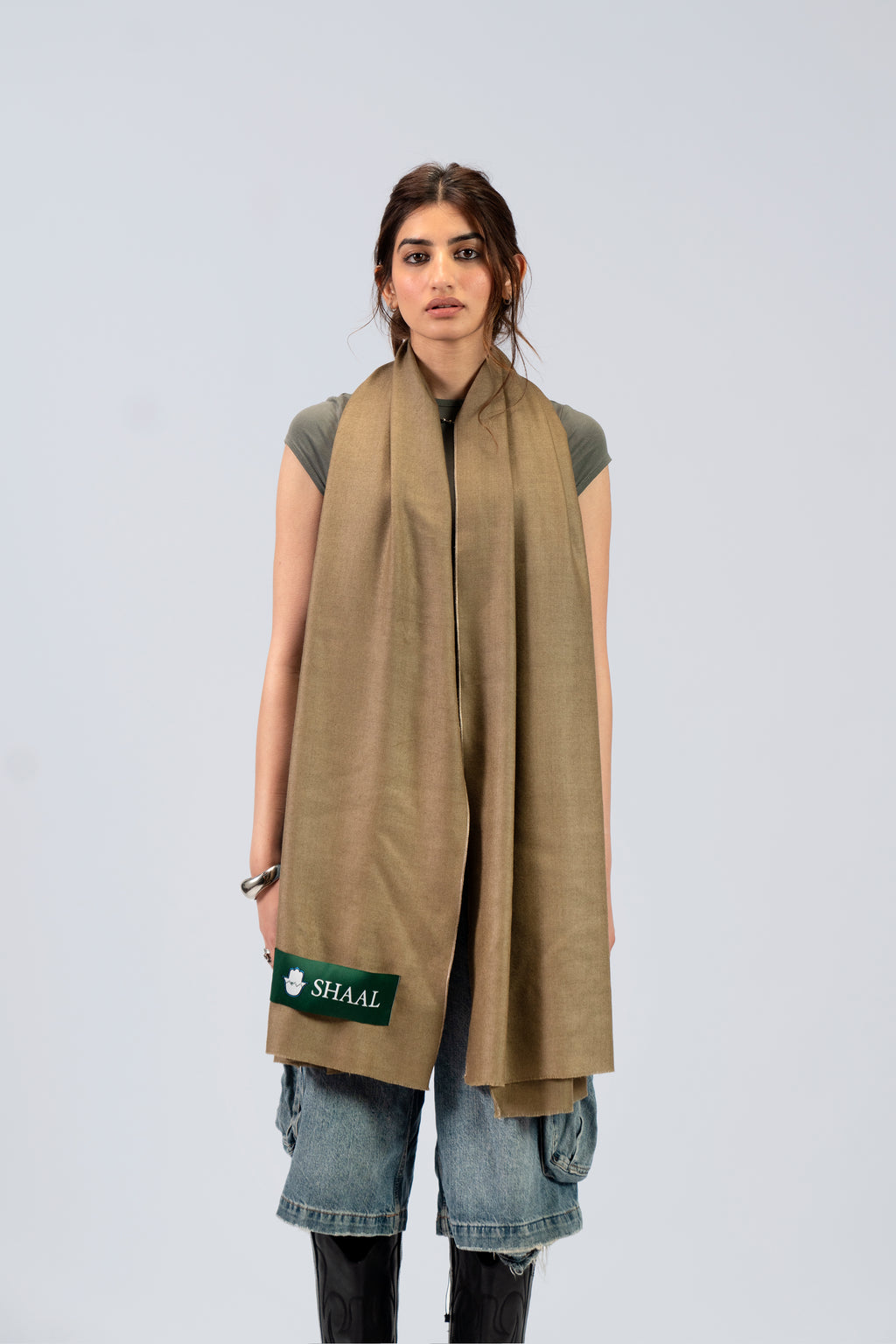 Gold pashmina shawl draped over shoulders on female model, full-length front view