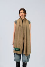 Gold pashmina shawl draped over shoulders on female model, full-length front view