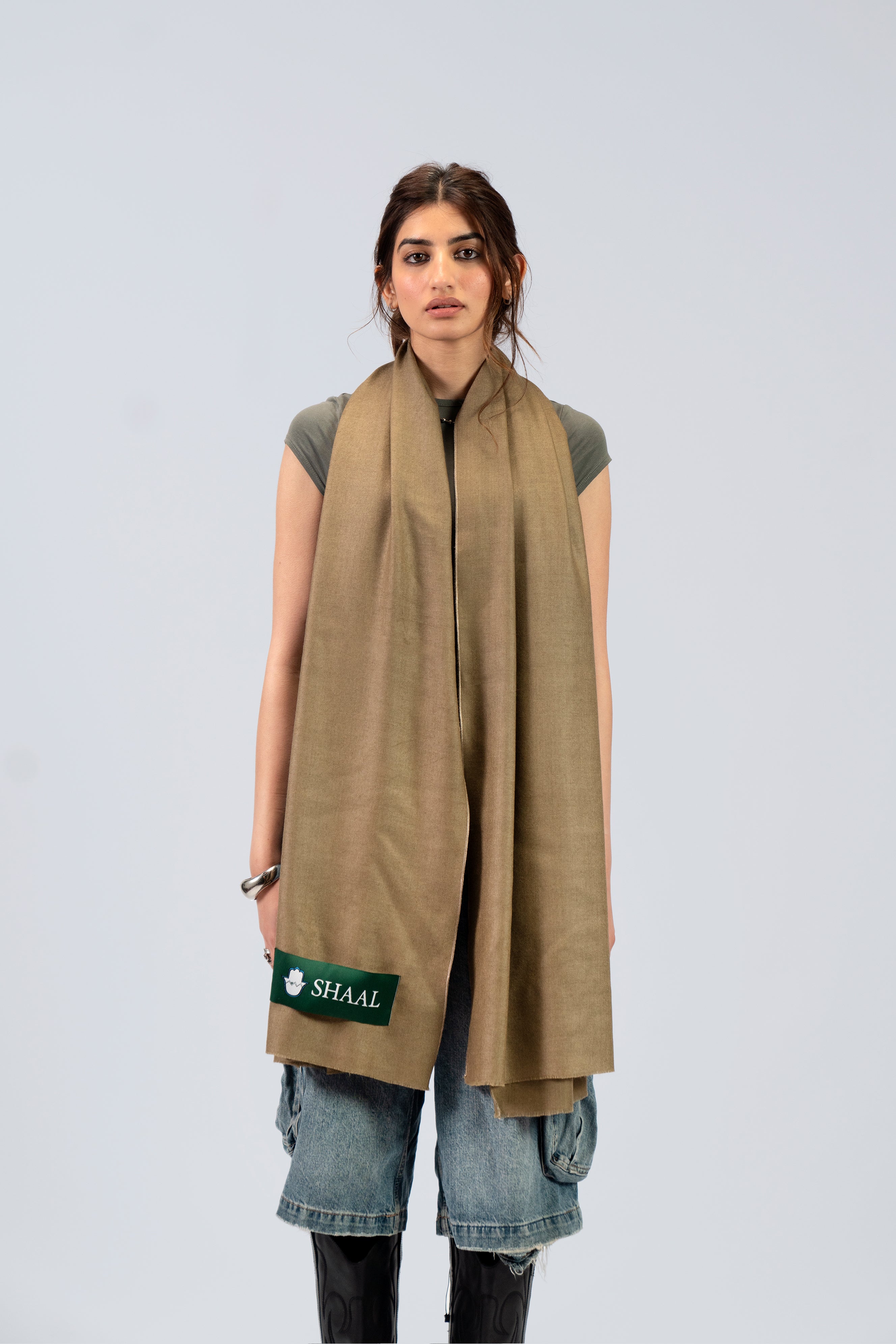 Gold pashmina shawl draped over shoulders on female model, full-length front view
